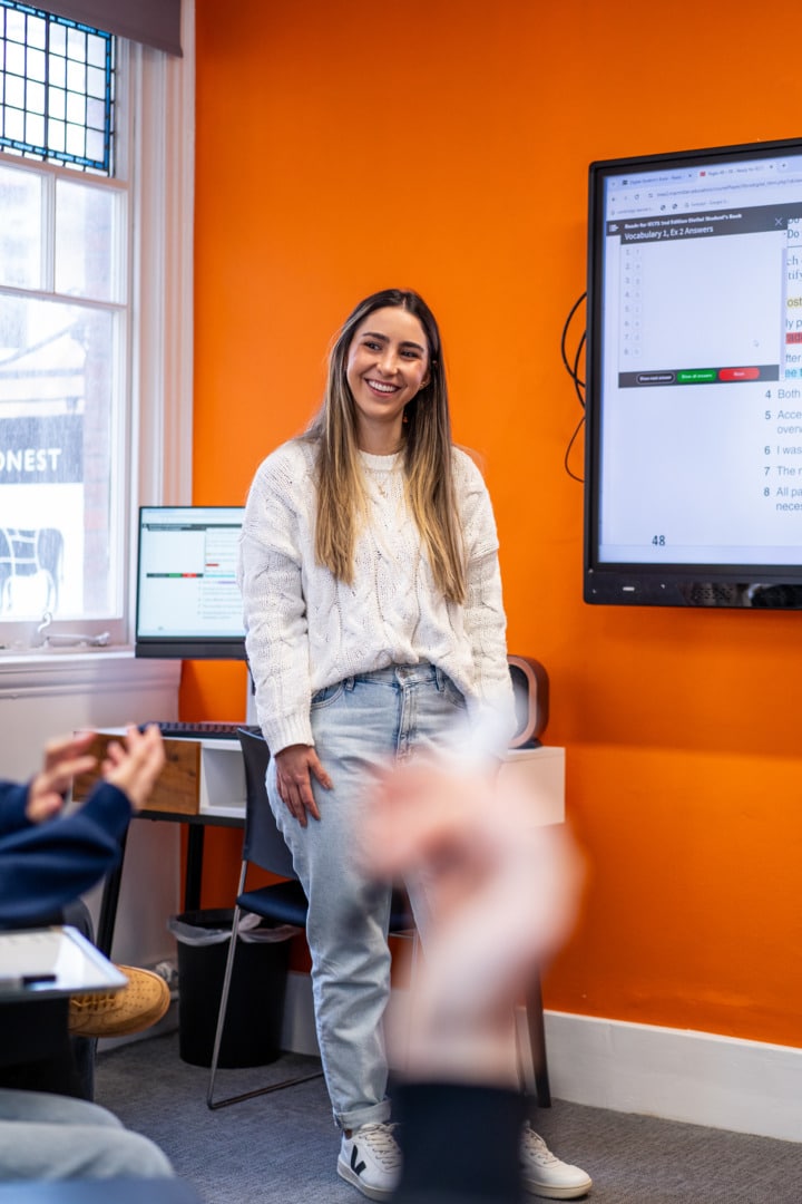 Student front of classroom smiling eccambridge