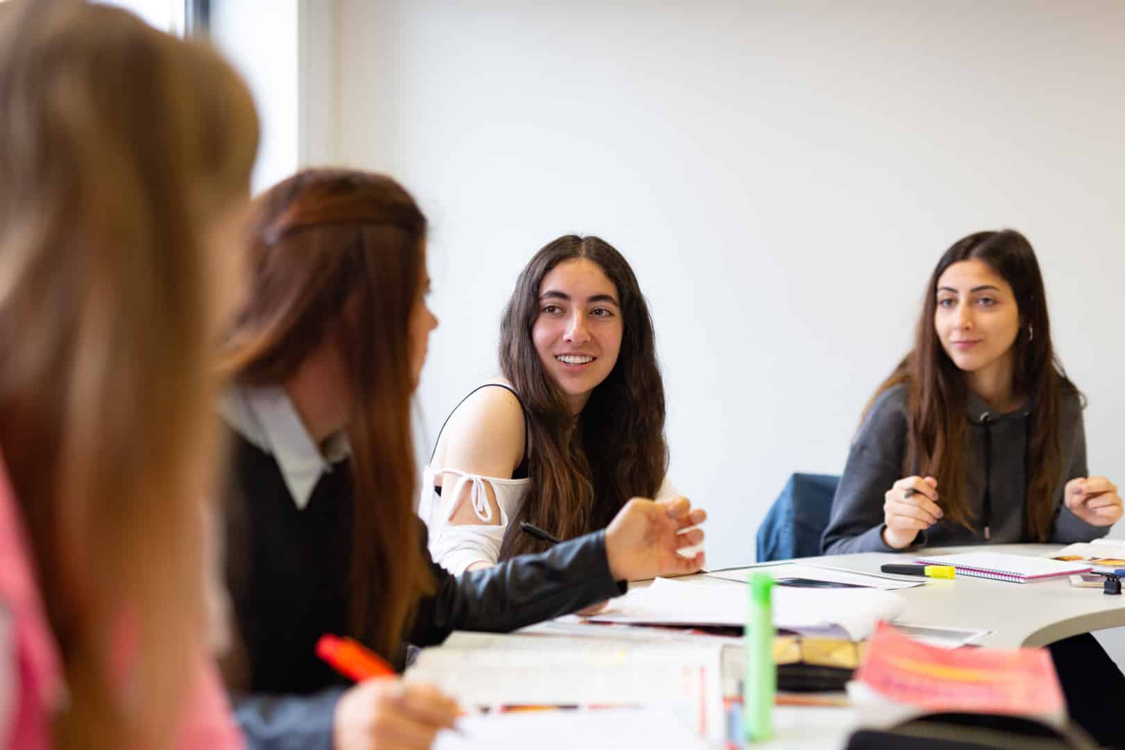 Students talking studying classroom eccambridge