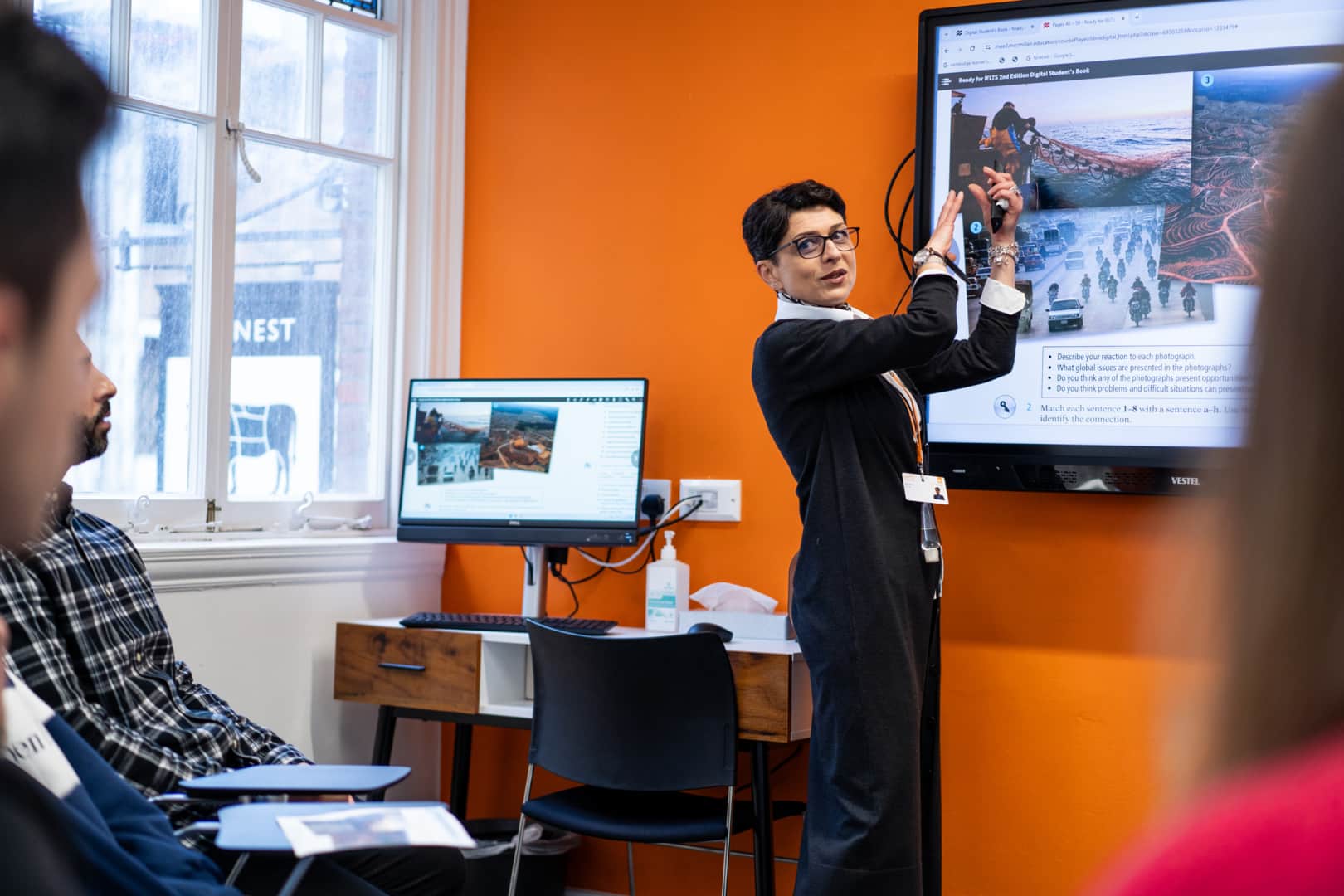 Teacher explaining digital board classroom eccambridge