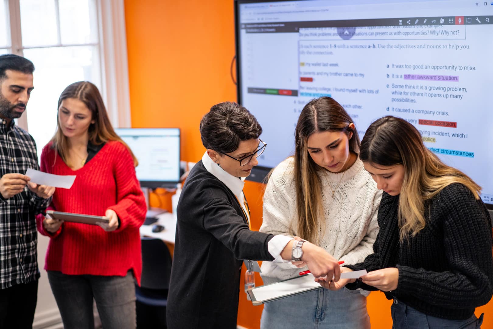 Teacher helping students exercise classroom eccambridge 2